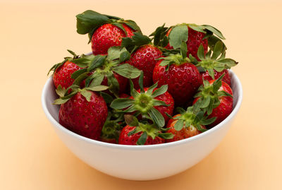 Close-up of strawberries in bowl on white background