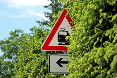 Low angle view of road sign against sky