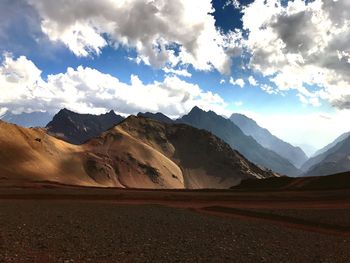 Scenic view of mountains against cloudy sky