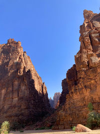 Rock formations against clear blue sky