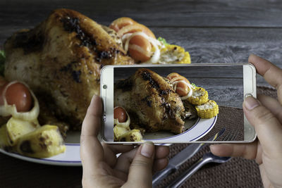 Midsection of person having food in plate