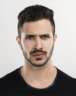 Portrait of young man against white background