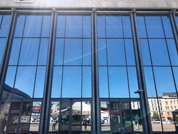 Reflection of buildings on glass window in city