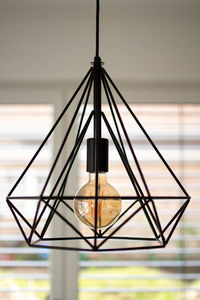 Black minimalist lamp in interior. loft lamps, vintage, retro, scandi style. edison's light bulb.