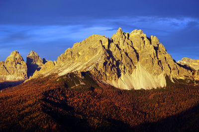 Scenic view of mountains against blue sky