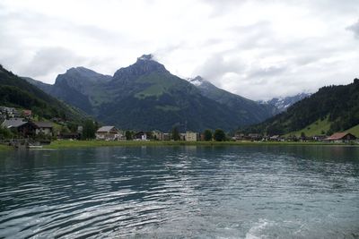 Scenic view of lake and mountains against sky