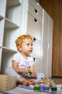 Cute girl playing with toys at home