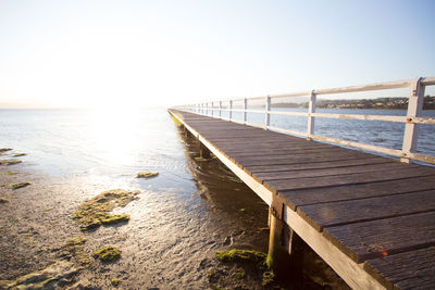 Pier over sea against clear sky