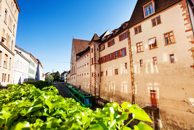 Low angle view of buildings against clear blue sky