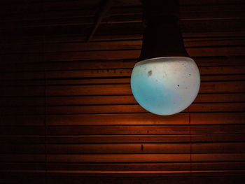 High angle view of illuminated light on wooden table