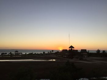 Scenic view of sea against clear sky during sunset