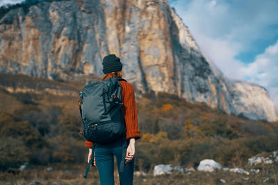 Rear view of man standing on rock