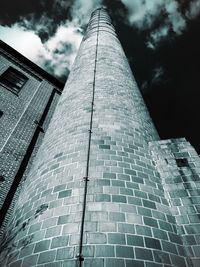 Low angle view of building against cloudy sky