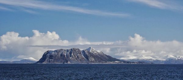 Panoramic view of sea and mountains against sky