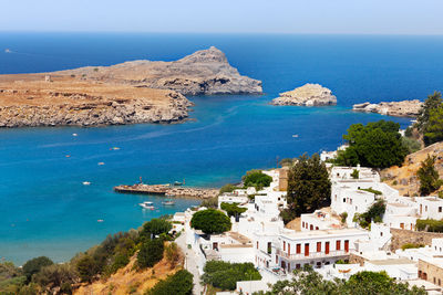 High angle view of sea and buildings against sky