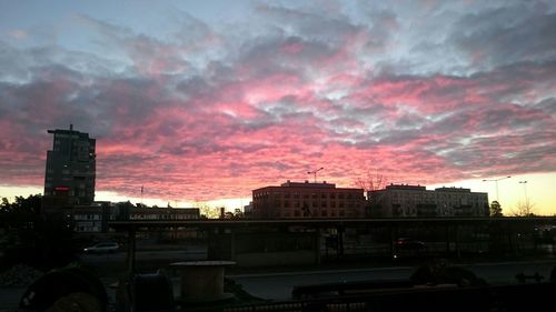 Buildings against cloudy sky at sunset