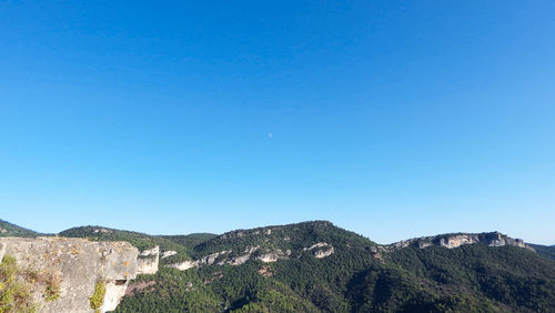 Scenic view of mountains against clear blue sky