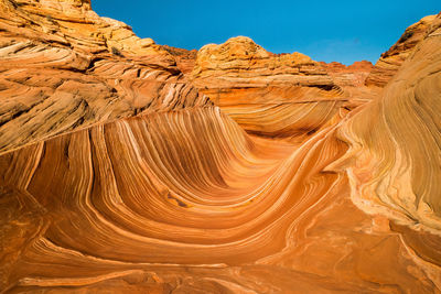 Scenic view of rock formations against clear blue sky