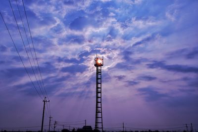 Low angle view of illuminated street light against sky