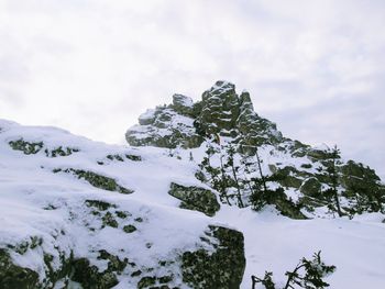 Low angle view of snow covered mountain against sky