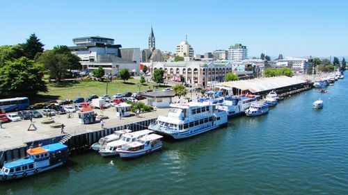 Boats in river with buildings in background