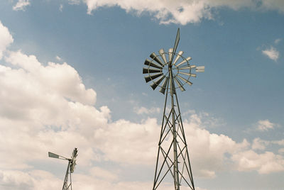 Low angle view of traditional windmill against sky