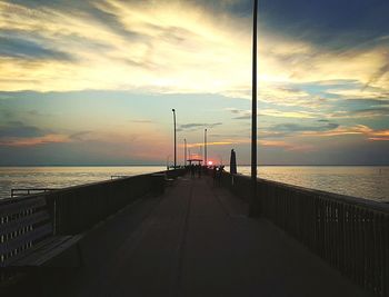 Pier on sea at sunset