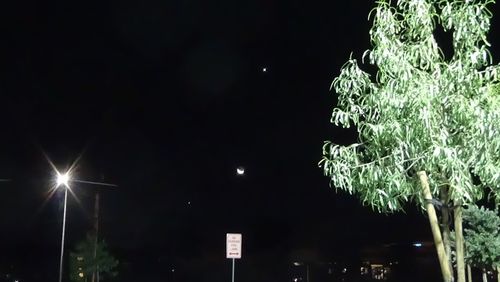 Low angle view of illuminated street light at night