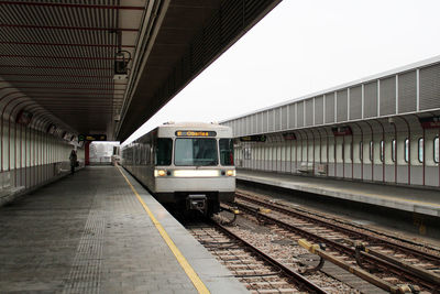 Train at railroad station against sky