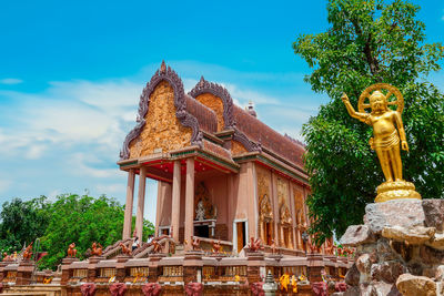 Statue outside temple against building