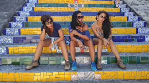 Female friends sitting on staircase