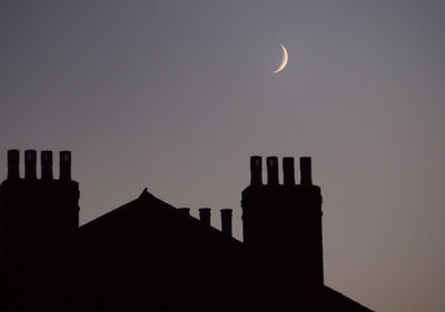 Low angle view of buildings against sky at sunset