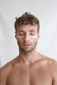 Portrait of young man against white background