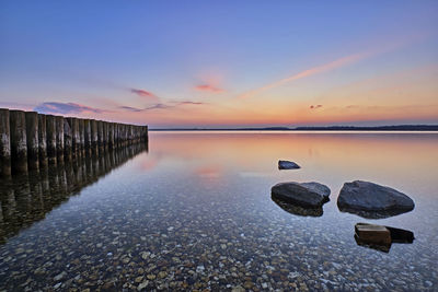 Scenic view of lake against sky during sunset