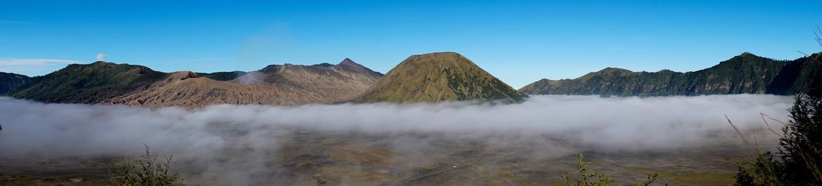 Panoramic view of mountains against clear blue sky