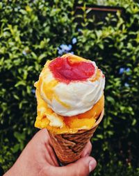 Close-up of hand holding ice cream cone