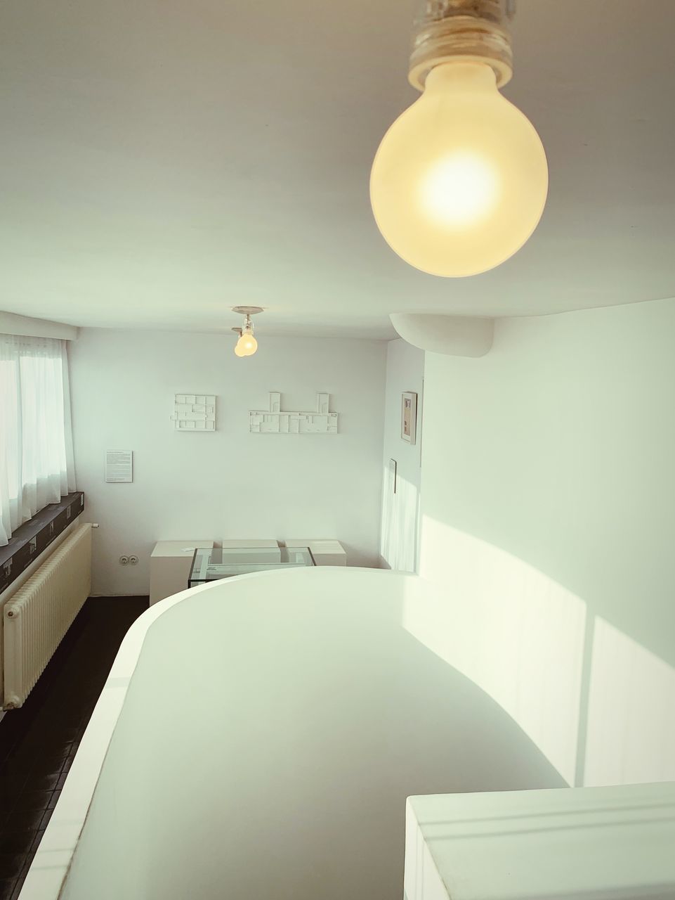 ILLUMINATED PENDANT LIGHTS HANGING ON CEILING OF HOME