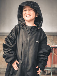 Full length of a smiling boy standing outdoors