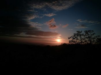 Silhouette landscape against sunset sky