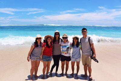 Portrait of friends standing on beach