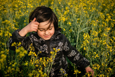 Upper view on walking in a blooming field smiling girl