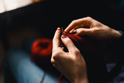 Cropped hand of woman holding flower