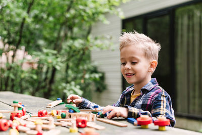 Cute boy playing with toys at home