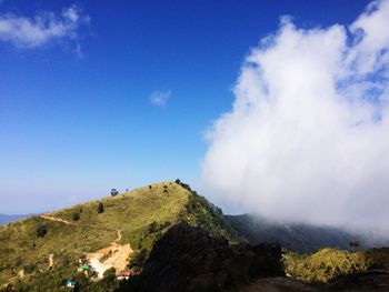 Scenic view of mountains against blue sky