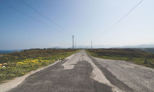 Road on field against clear sky