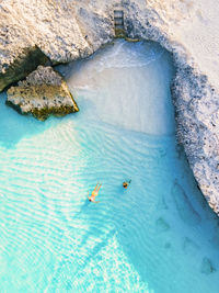 High angle view of man swimming in sea