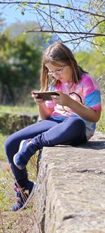 Young woman sitting on rock