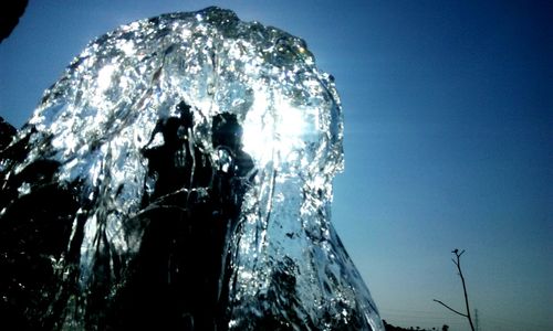 Low angle view of people against blue sky