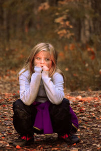 Full length of girl sitting outdoors