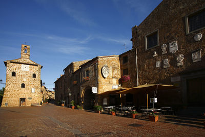 Street amidst buildings in city against sky